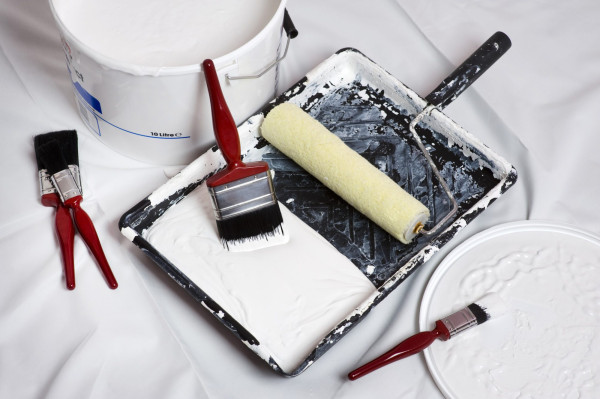 Painting and decorating. Paint brushes and roller of a home decorator