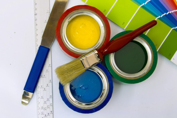 Supplies for painting consisting of brushes, paints, sound card mixer and ruler on a white background