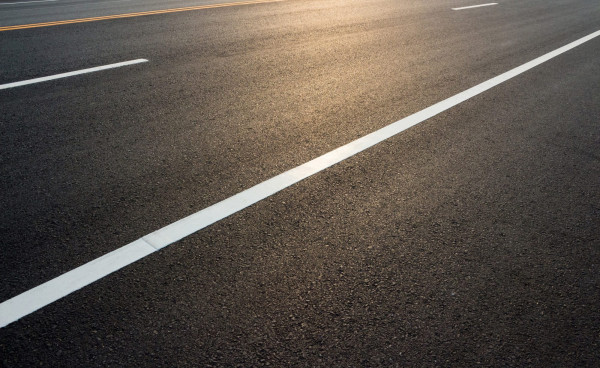 Road markings on asphalt empty space for text messages.
